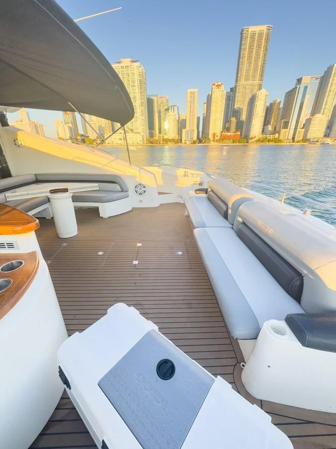 The aft deck offers a spacious seating area with a stunning cityscape backdrop. aboard THE GAMBLER Yacht for Sale