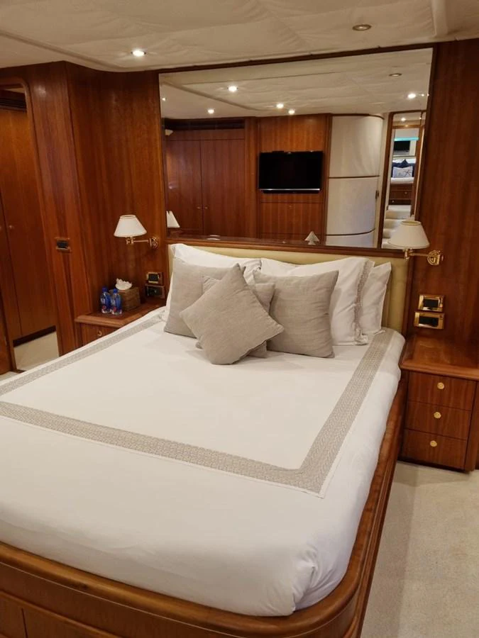 a bed with white sheets aboard LADY AMANDA Yacht for Sale