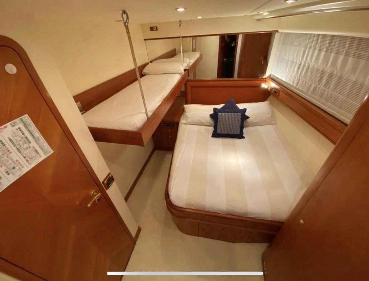 a room with a bed and a desk aboard LADY AMANDA Yacht for Sale