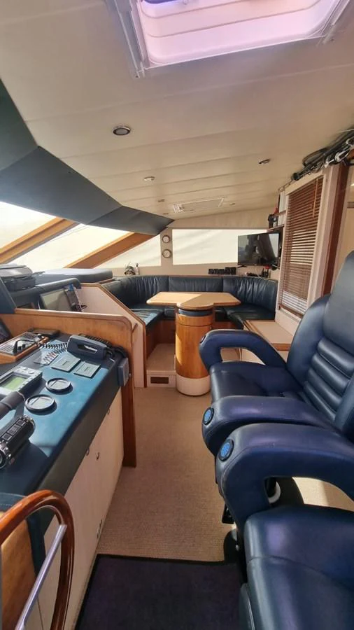 a room with a table and chairs aboard LADY AMANDA Yacht for Sale