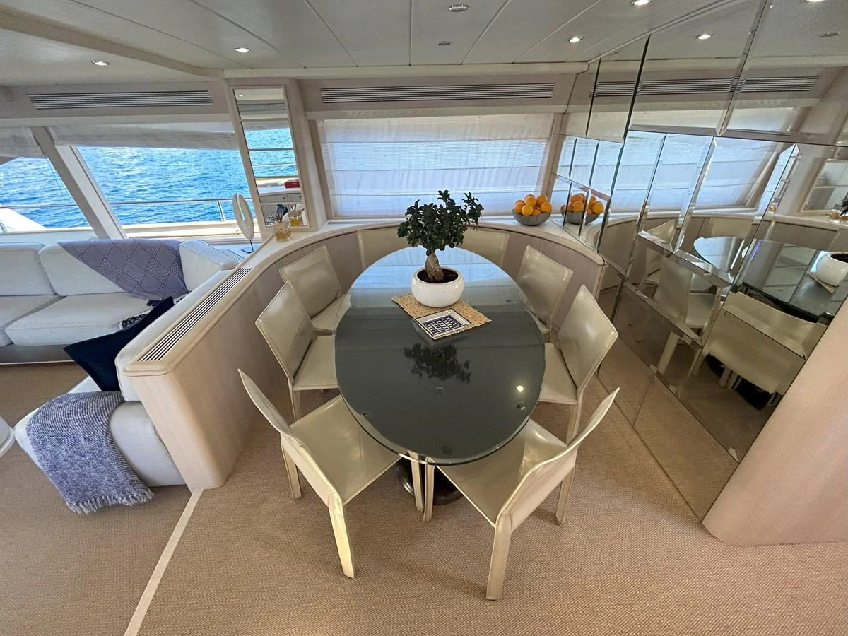 a room with a table and chairs aboard LADY AMANDA Yacht for Sale
