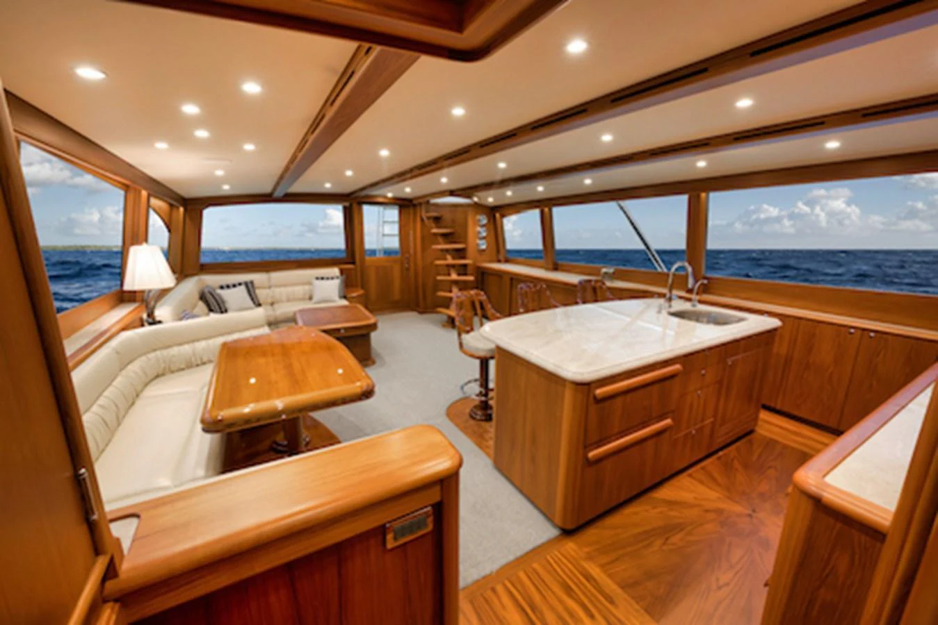 The yacht's salon offers a spacious and elegant area with ample seating and a well-equipped galley, all framed by panoramic windows. aboard BREE Yacht for Sale