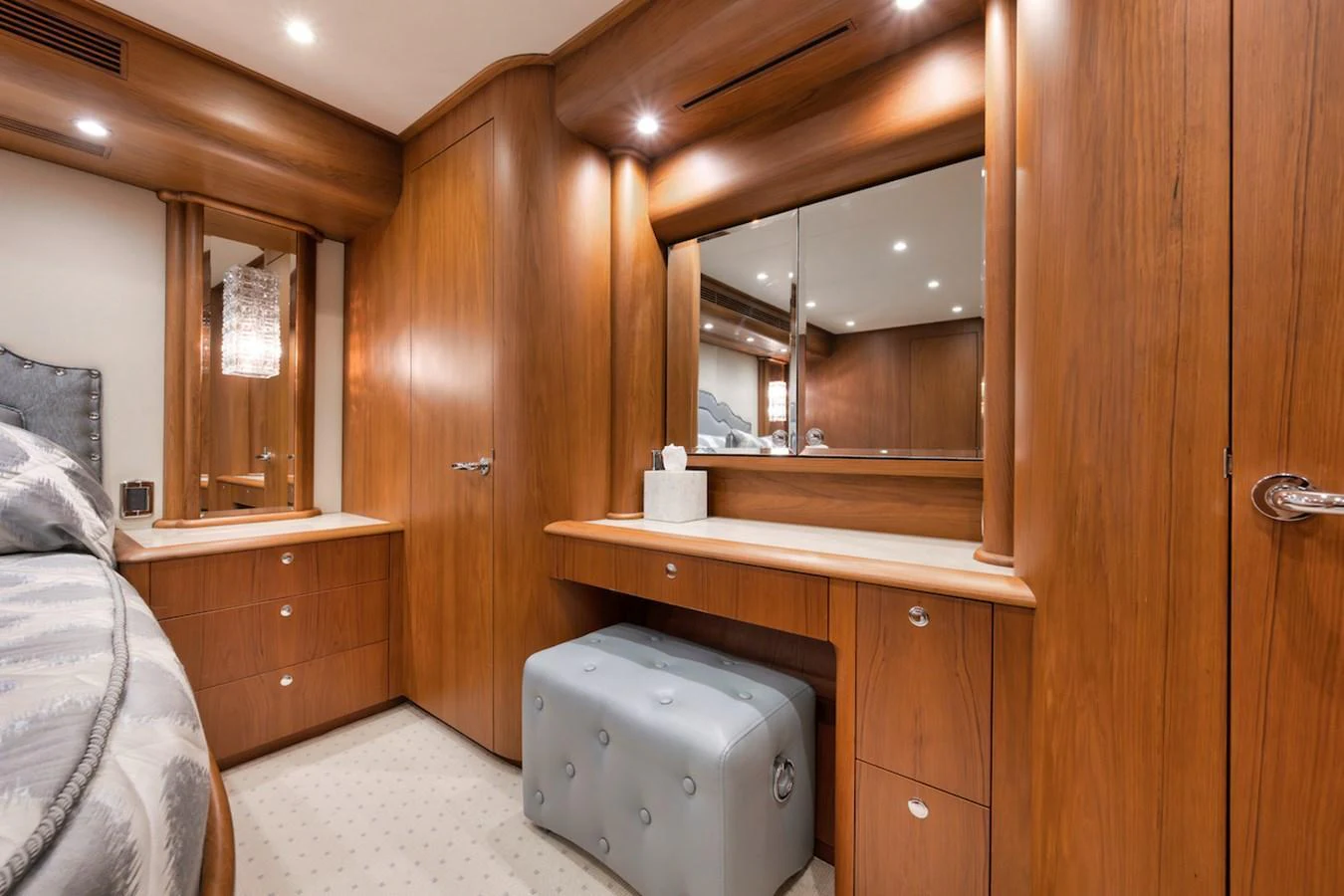 The yacht's stateroom features elegant wooden cabinetry and a plush ottoman, creating a warm and inviting atmosphere. aboard BREE Yacht for Sale