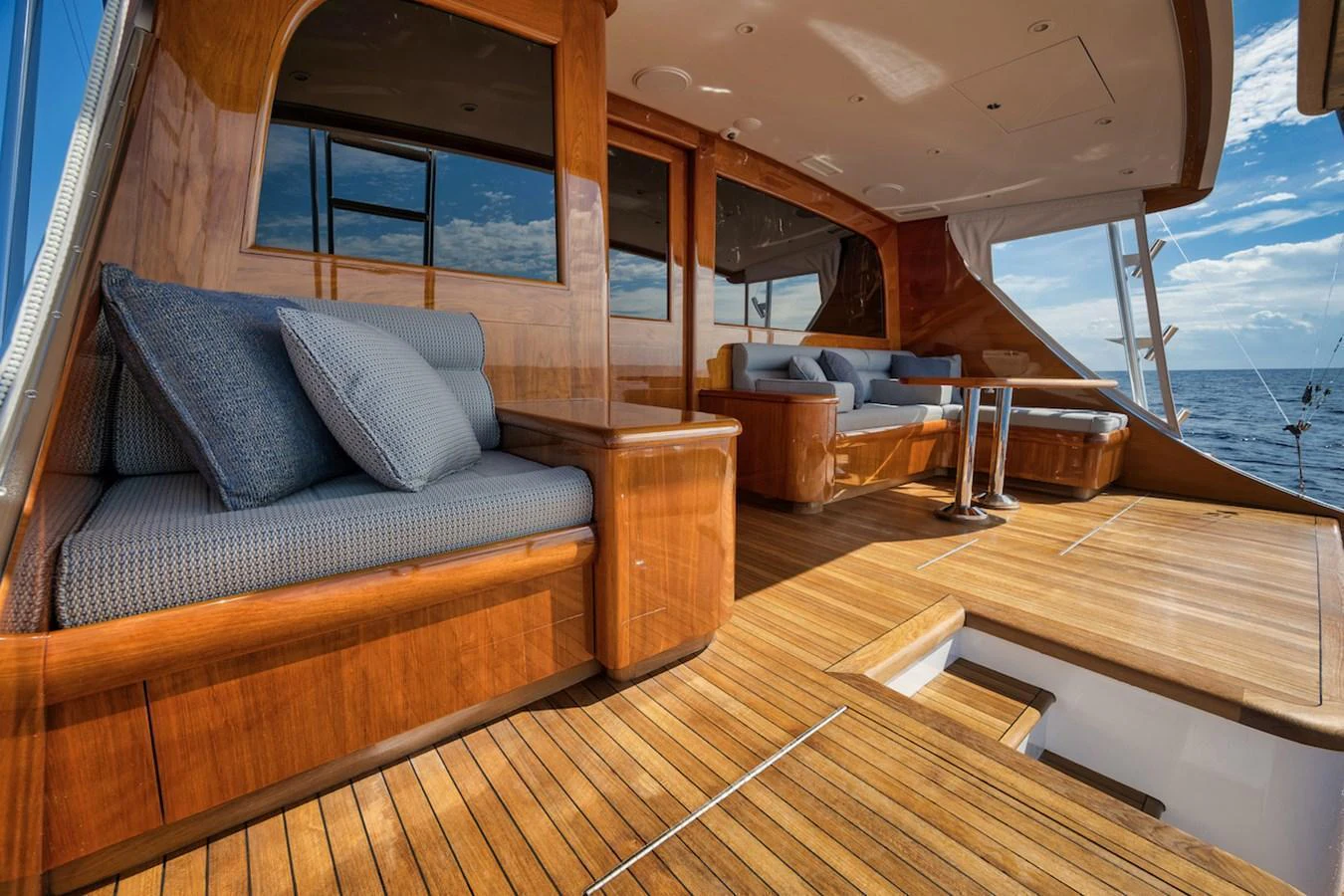 The aft deck features luxurious wooden finishes and comfortable seating with a stunning ocean view. aboard BREE Yacht for Sale