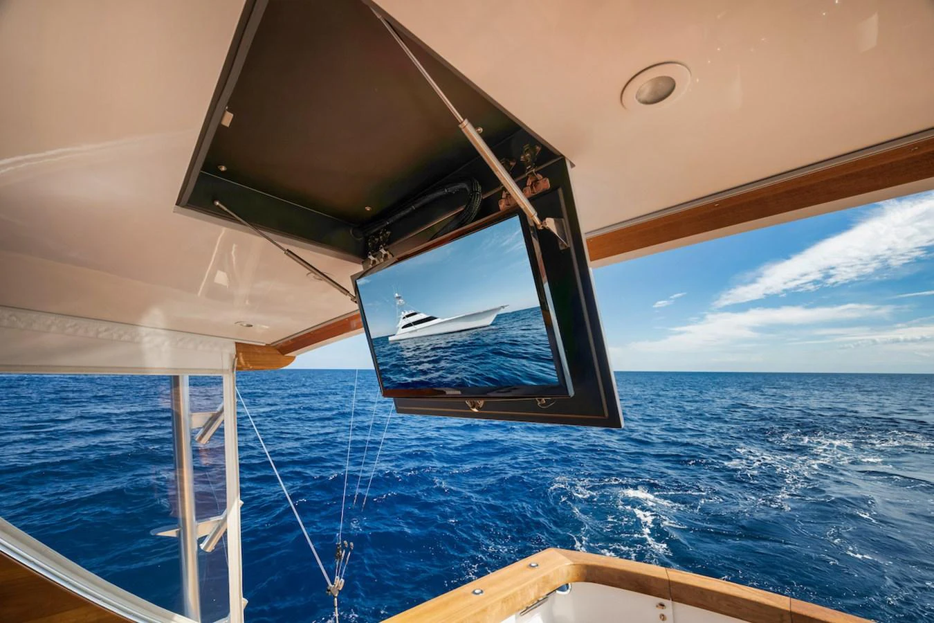 An outdoor entertainment area featuring a retractable TV screen with a stunning ocean view. aboard BREE Yacht for Sale