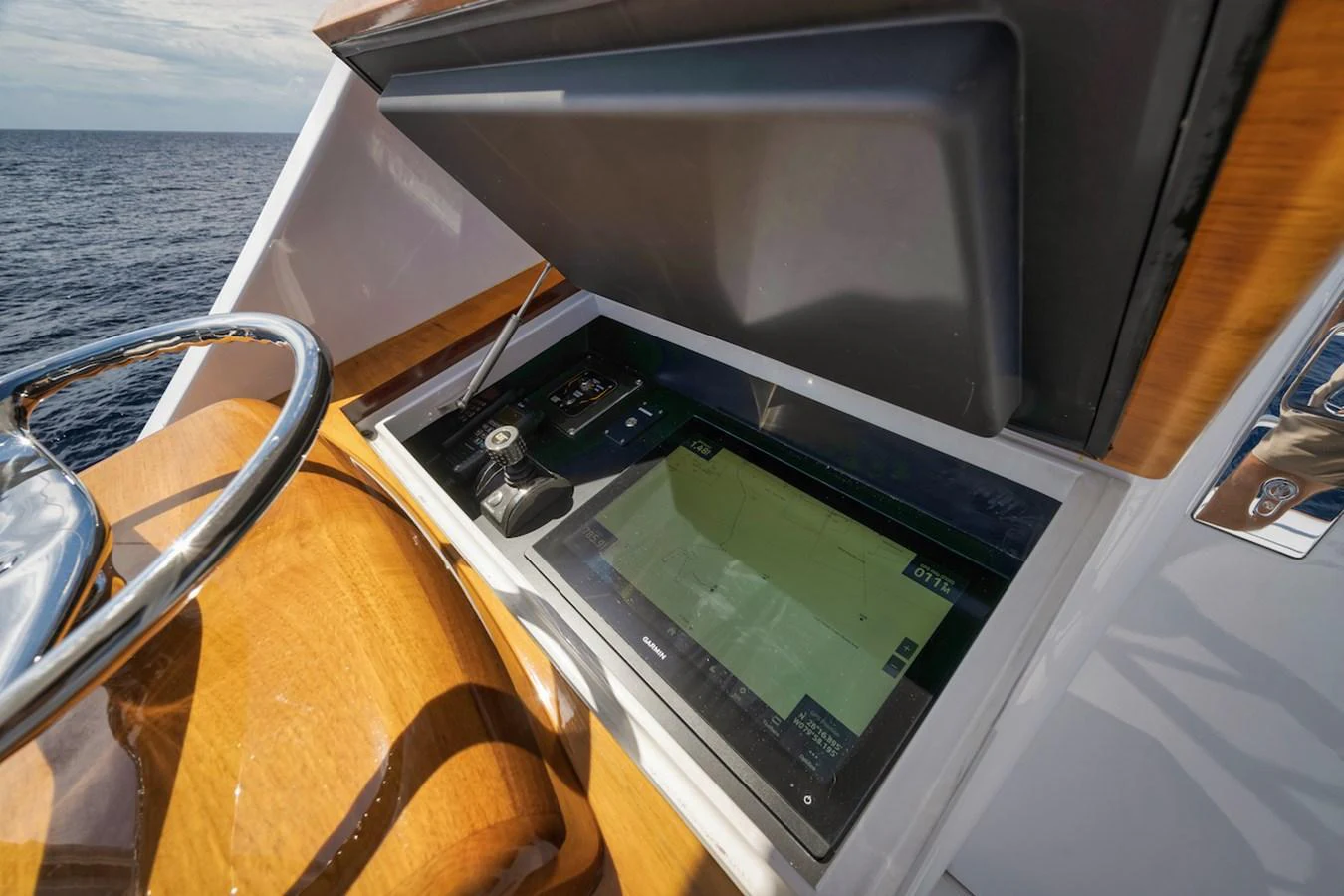 The helm station features advanced navigation equipment and a sleek wooden finish. aboard BREE Yacht for Sale