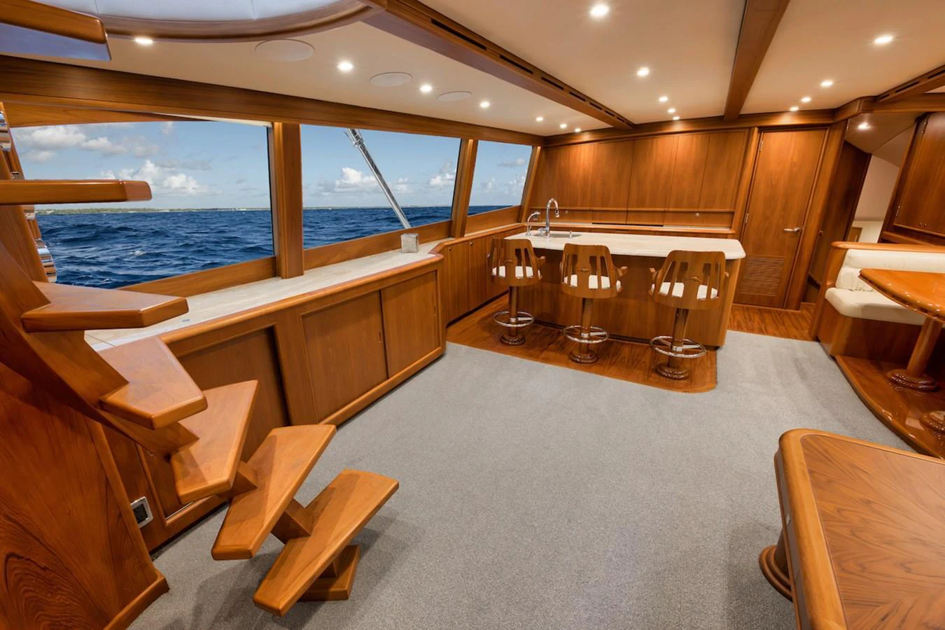 The salon features elegant wooden finishes and expansive ocean views through large windows. aboard BREE Yacht for Sale