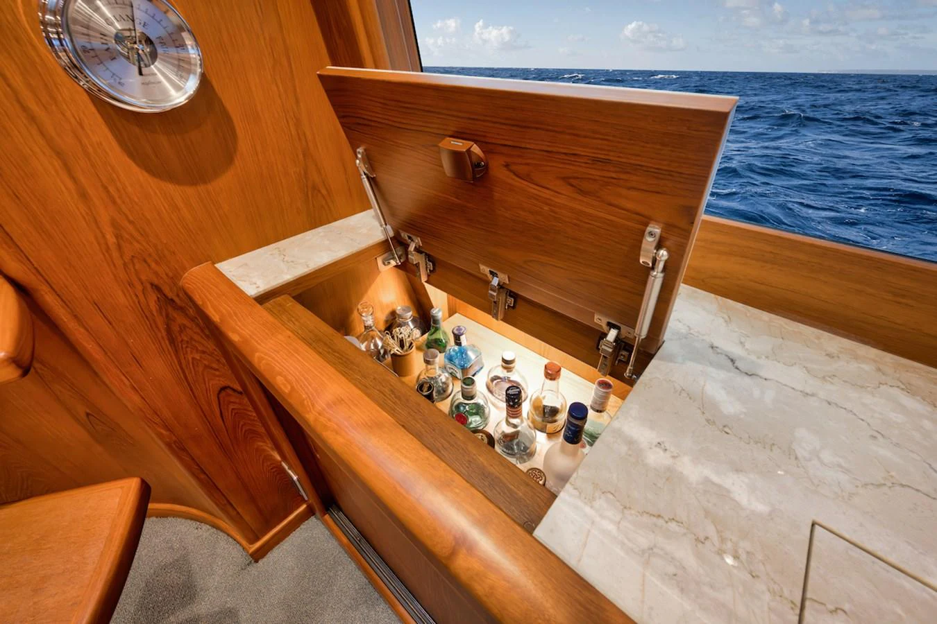 A hidden compartment on the yacht reveals a well-stocked liquor cabinet, blending luxury with clever design. aboard BREE Yacht for Sale