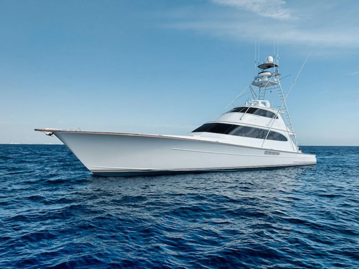 A sleek and modern yacht glides gracefully on the open sea under a clear blue sky. aboard BREE Yacht for Sale