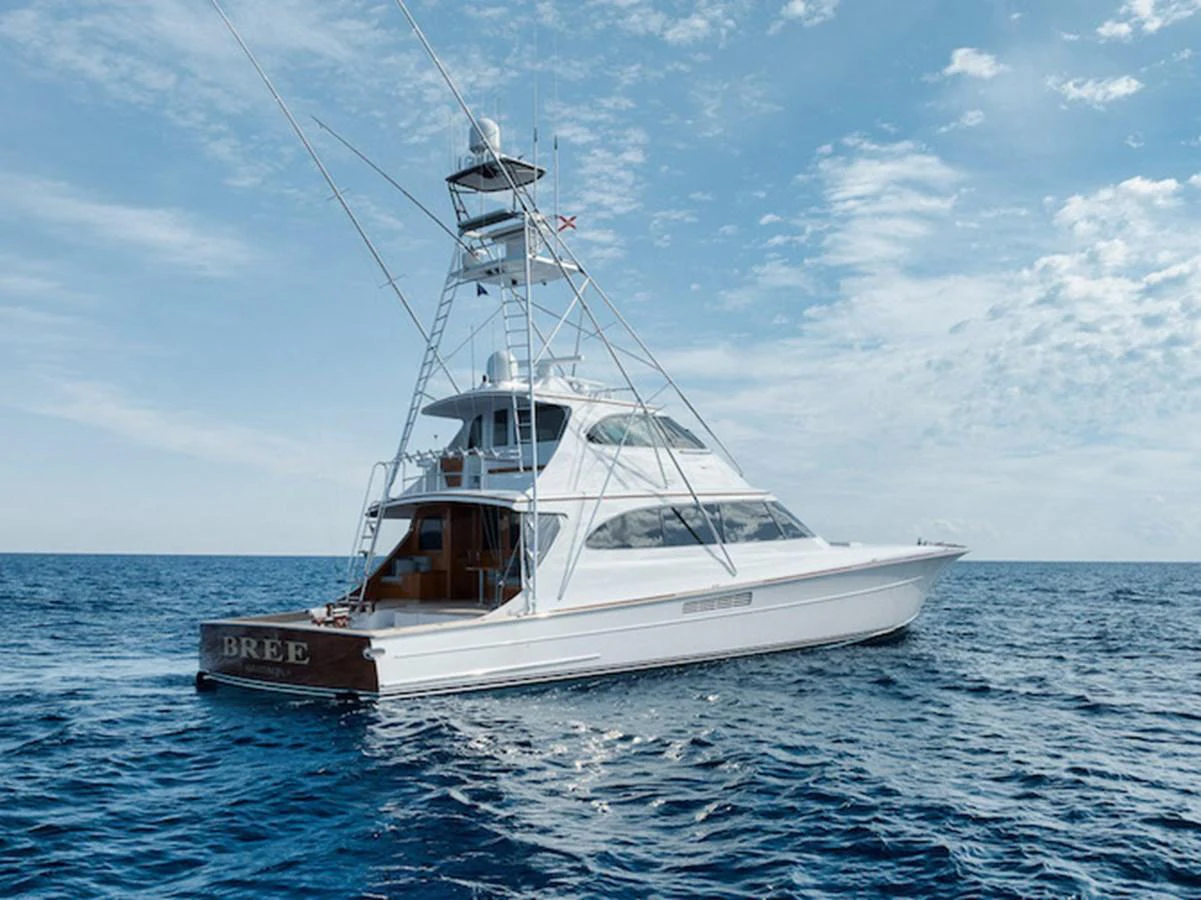 A sleek yacht cruises gracefully on the open sea under a clear blue sky. aboard BREE Yacht for Sale
