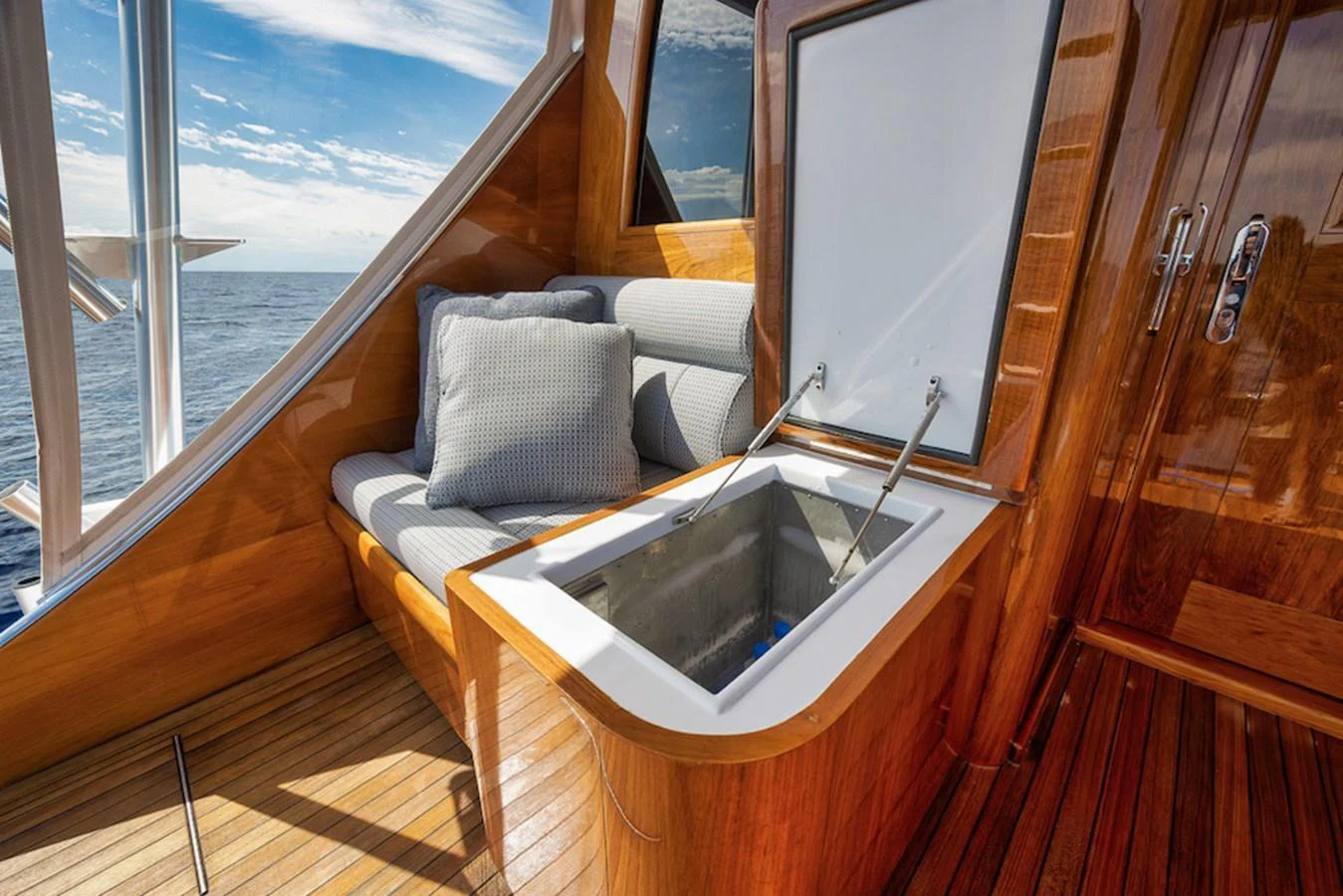 A cozy seating area with a built-in cooler, perfect for relaxing and enjoying the view. aboard BREE Yacht for Sale