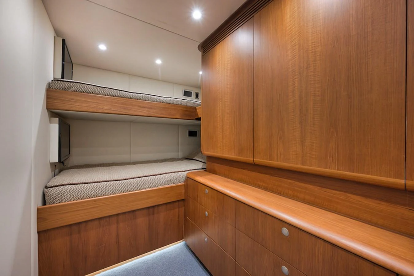 The guest cabin features cozy bunk beds and ample storage space with elegant wooden cabinetry. aboard BREE Yacht for Sale