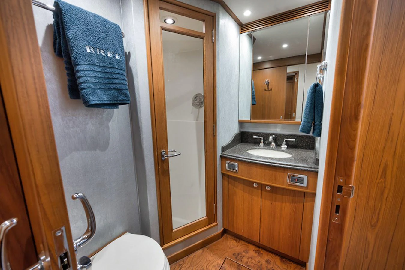 A well-appointed bathroom with wooden cabinetry and modern fixtures. aboard BREE Yacht for Sale