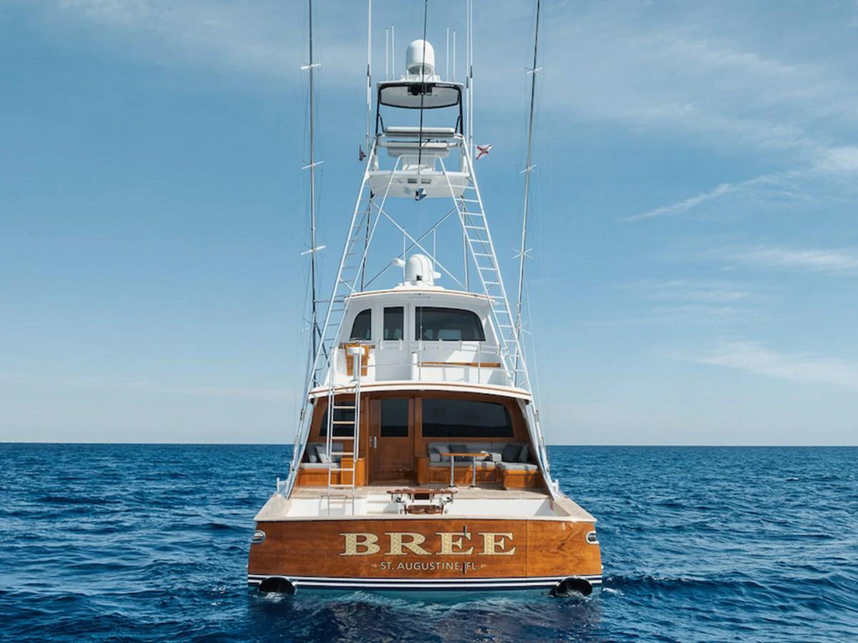 A stunning yacht with a wooden transom and sleek lines, captured from the rear on open water. aboard BREE Yacht for Sale