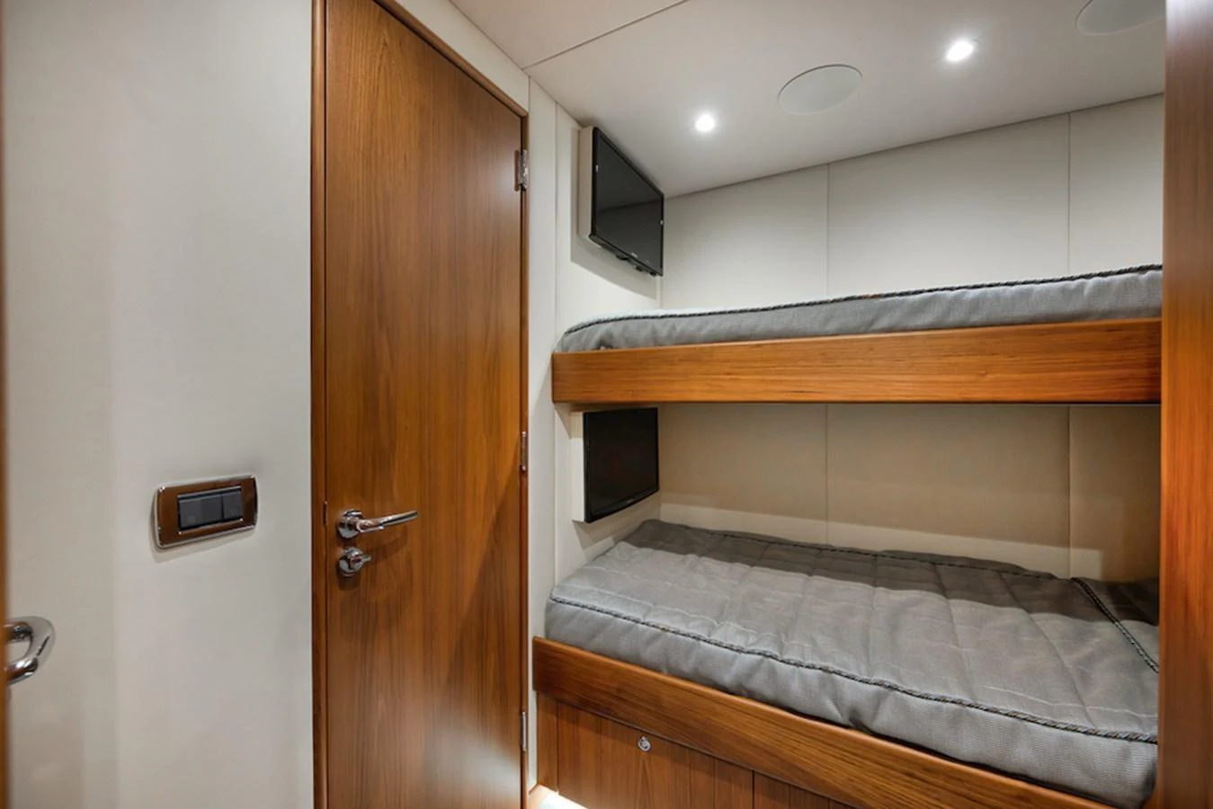 The crew cabin features cozy bunk beds with a sleek wooden finish and modern lighting. aboard BREE Yacht for Sale