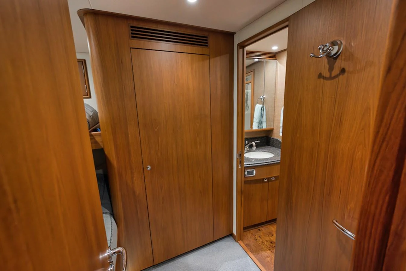 A cozy yacht bathroom with wooden cabinetry and a modern sink area. aboard BREE Yacht for Sale