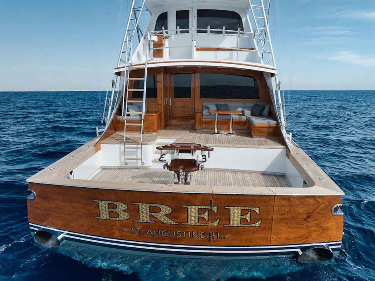The yacht features a spacious aft deck with elegant wooden finishes and comfortable seating, perfect for relaxation and fishing. aboard BREE Yacht for Sale