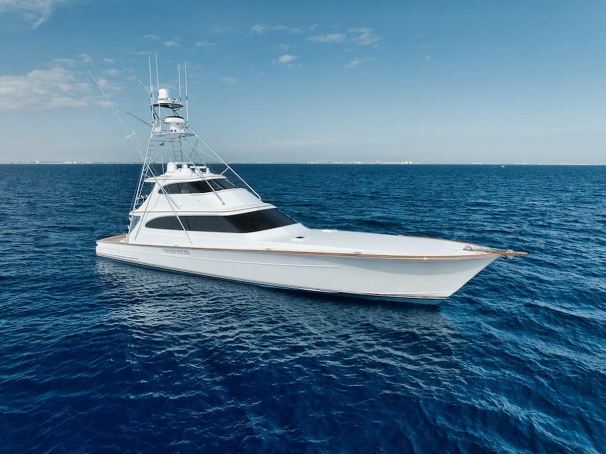 A sleek yacht glides gracefully on the open sea under a clear blue sky. aboard BREE Yacht for Sale