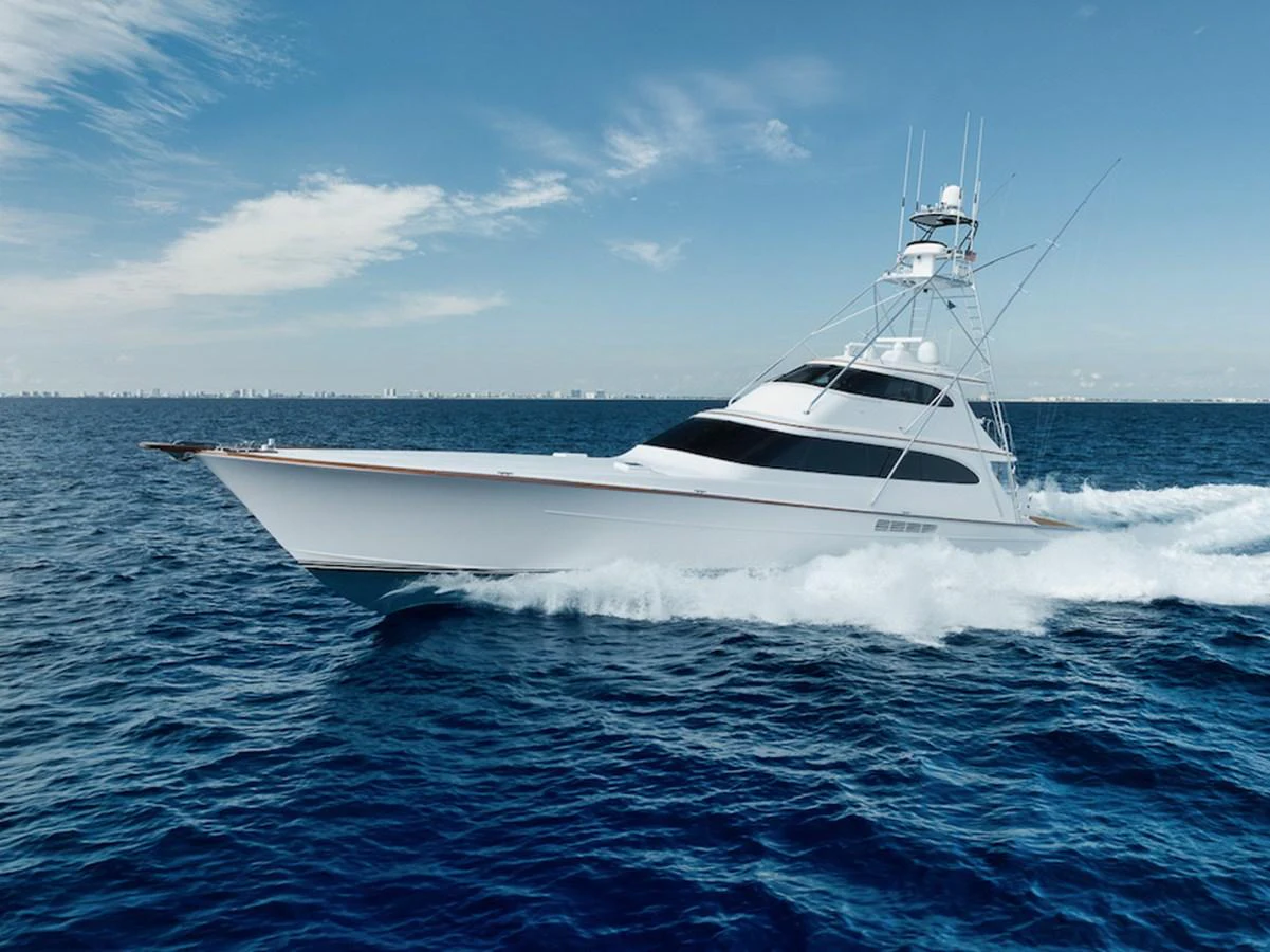 A sleek yacht cruises swiftly through the open sea under a clear blue sky. aboard BREE Yacht for Sale