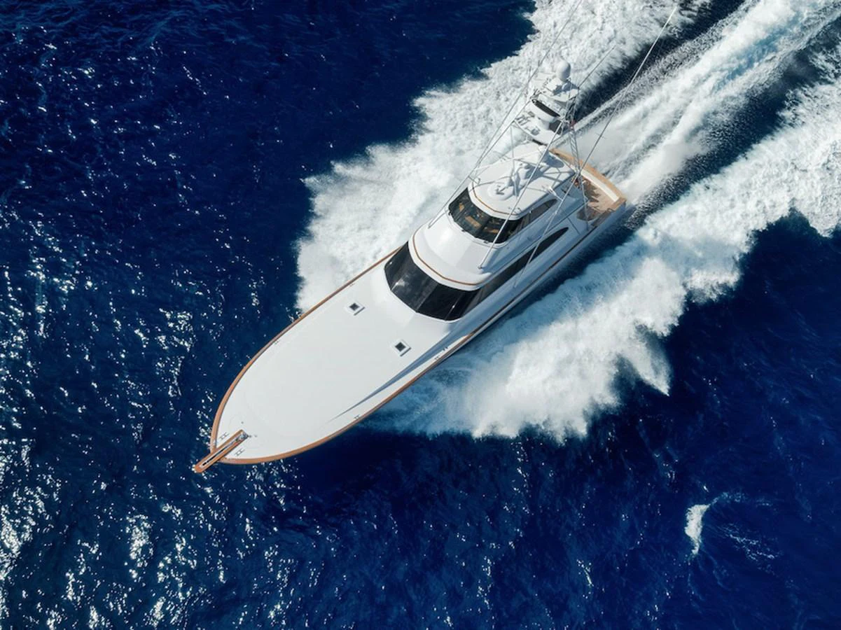 A sleek yacht cruises swiftly through the deep blue ocean, leaving a trail of white foam in its wake. aboard BREE Yacht for Sale
