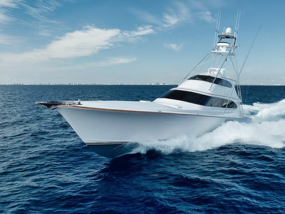 A sleek yacht cruises swiftly through the open sea under a clear blue sky. aboard BREE Yacht for Sale