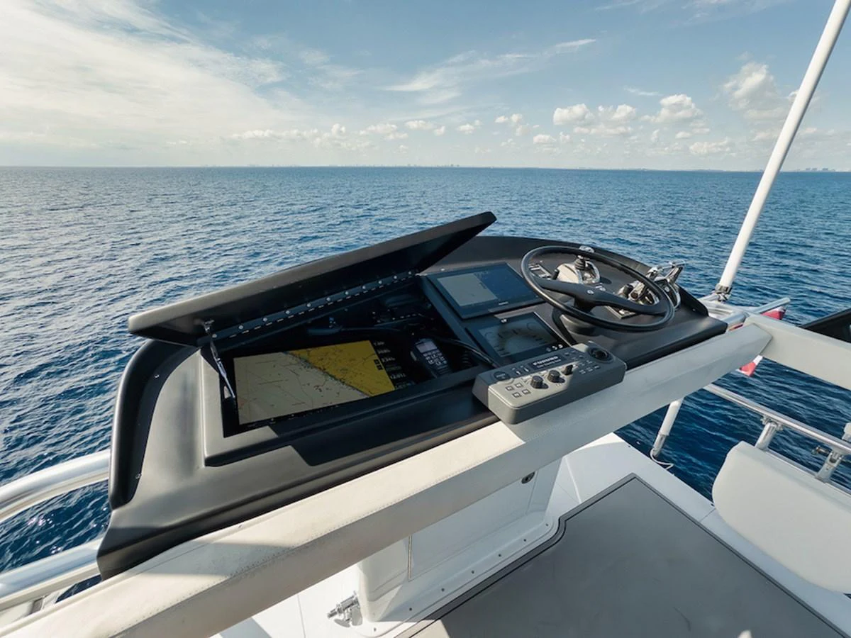 The helm station offers advanced navigation equipment with a stunning ocean view. aboard BREE Yacht for Sale