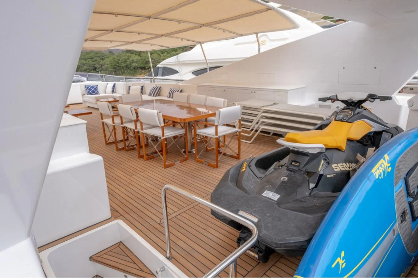 The aft deck features a spacious dining area and a jet ski for water sports enthusiasts. aboard PARSLEY Yacht for Sale