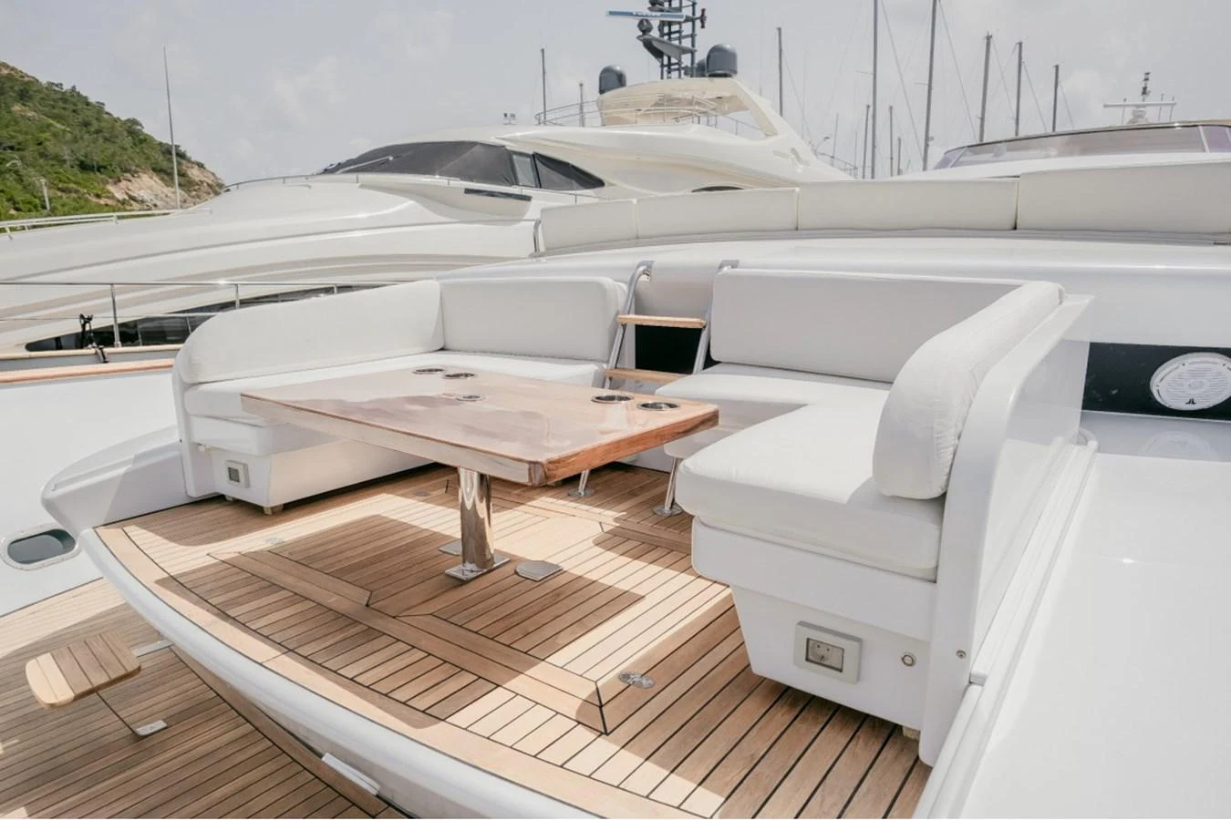 The aft deck features a spacious seating area with a wooden table, perfect for outdoor relaxation and dining. aboard PARSLEY Yacht for Sale