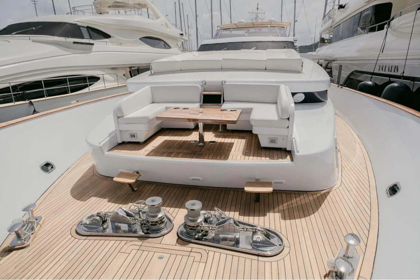 The foredeck features a spacious seating area with a wooden table, perfect for relaxation and socializing. aboard PARSLEY Yacht for Sale