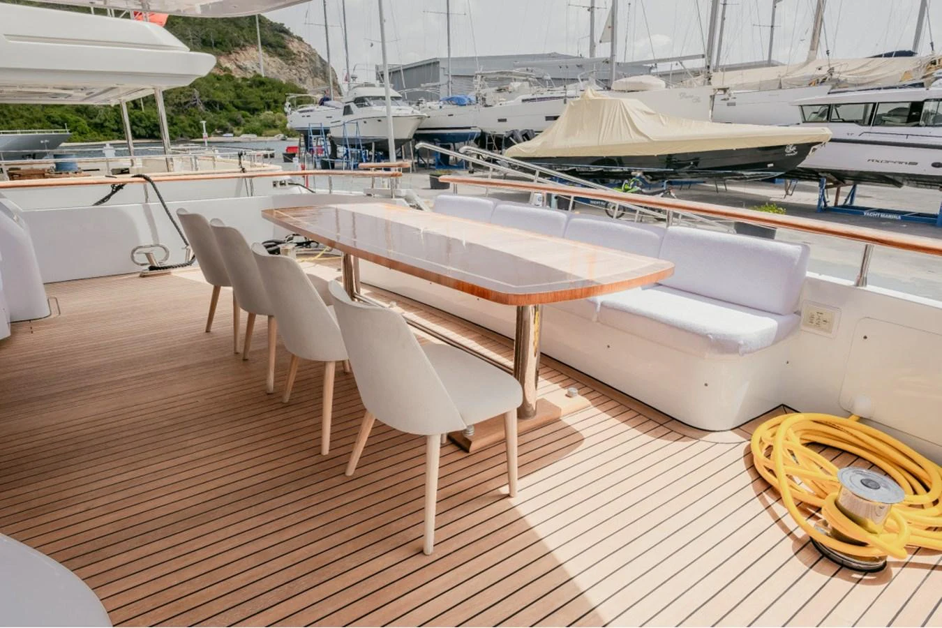 The aft deck features a spacious dining area with a sleek table and comfortable seating, perfect for alfresco meals. aboard PARSLEY Yacht for Sale