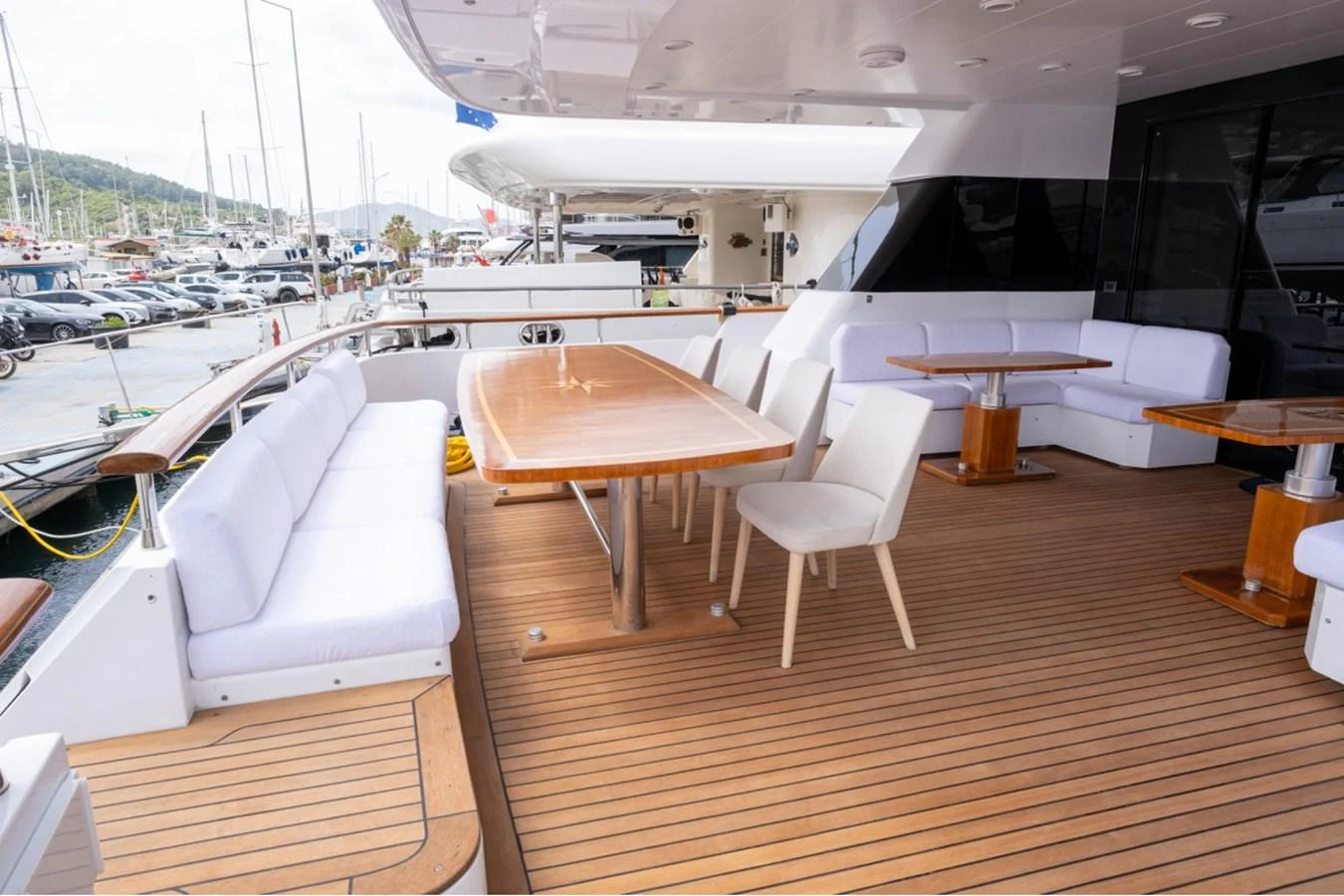 The aft deck features a spacious seating area with a large dining table, perfect for alfresco dining. aboard PARSLEY Yacht for Sale
