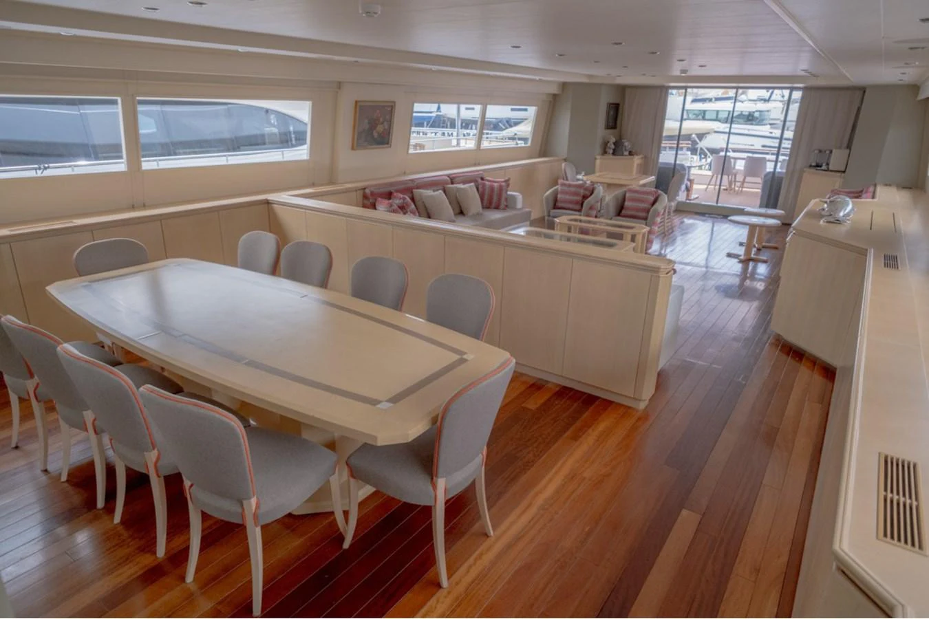 The spacious salon features a dining area and a comfortable seating arrangement with ample natural light. aboard PARSLEY Yacht for Sale