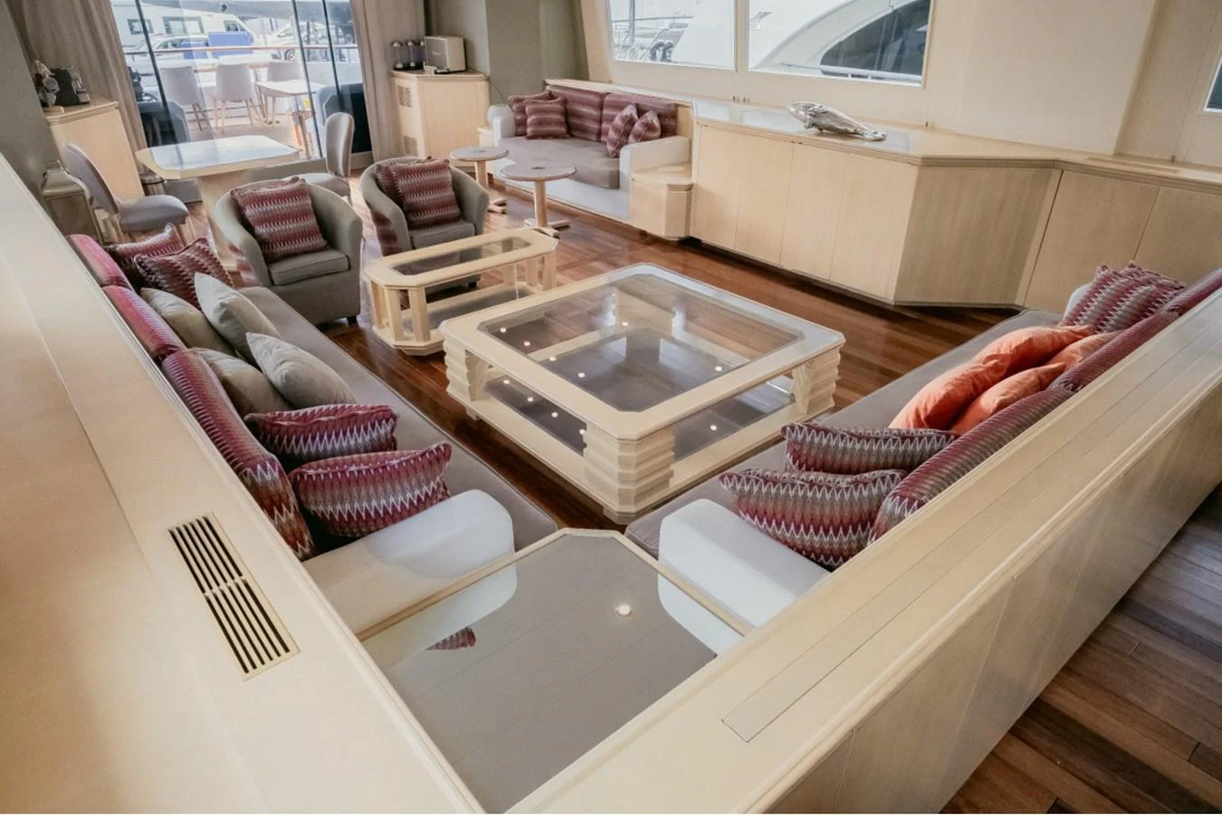 The salon features plush seating and a stylish glass coffee table, creating a welcoming and elegant atmosphere. aboard PARSLEY Yacht for Sale