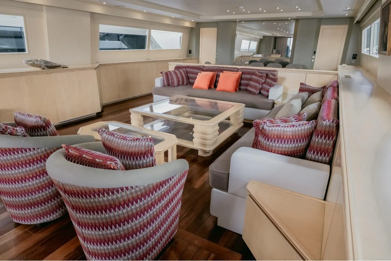 The salon features a spacious seating area with stylish, patterned upholstery and a modern coffee table. aboard PARSLEY Yacht for Sale