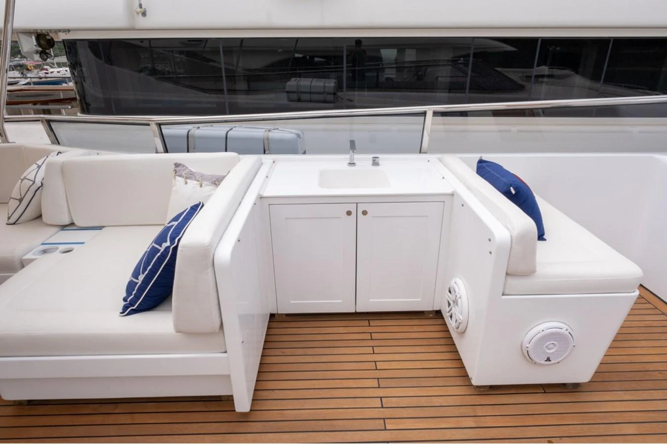 The yacht features a comfortable deck seating area with a built-in sink and storage. aboard PARSLEY Yacht for Sale