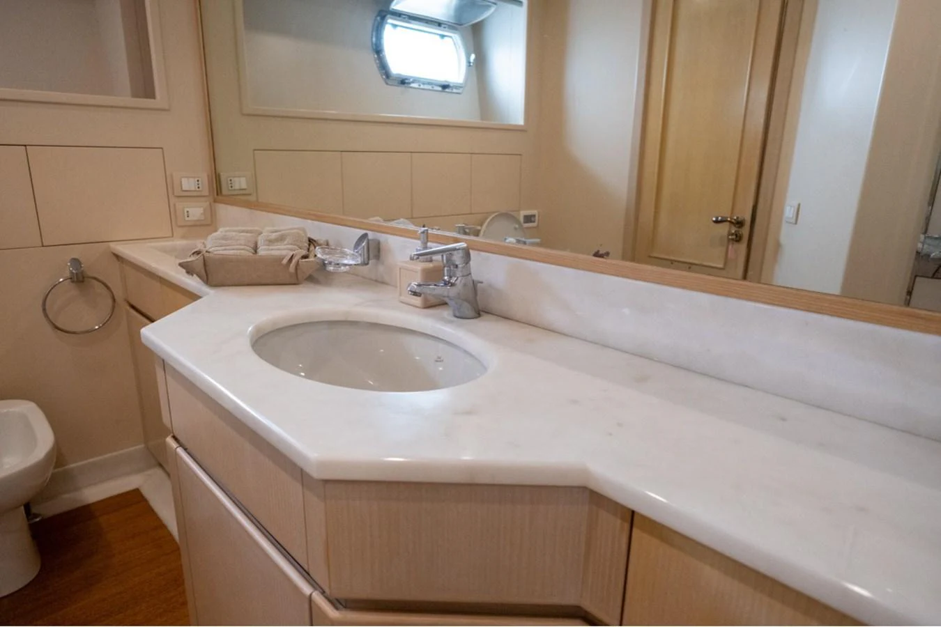 The yacht's bathroom features a sleek, modern design with a spacious countertop and elegant fixtures. aboard PARSLEY Yacht for Sale