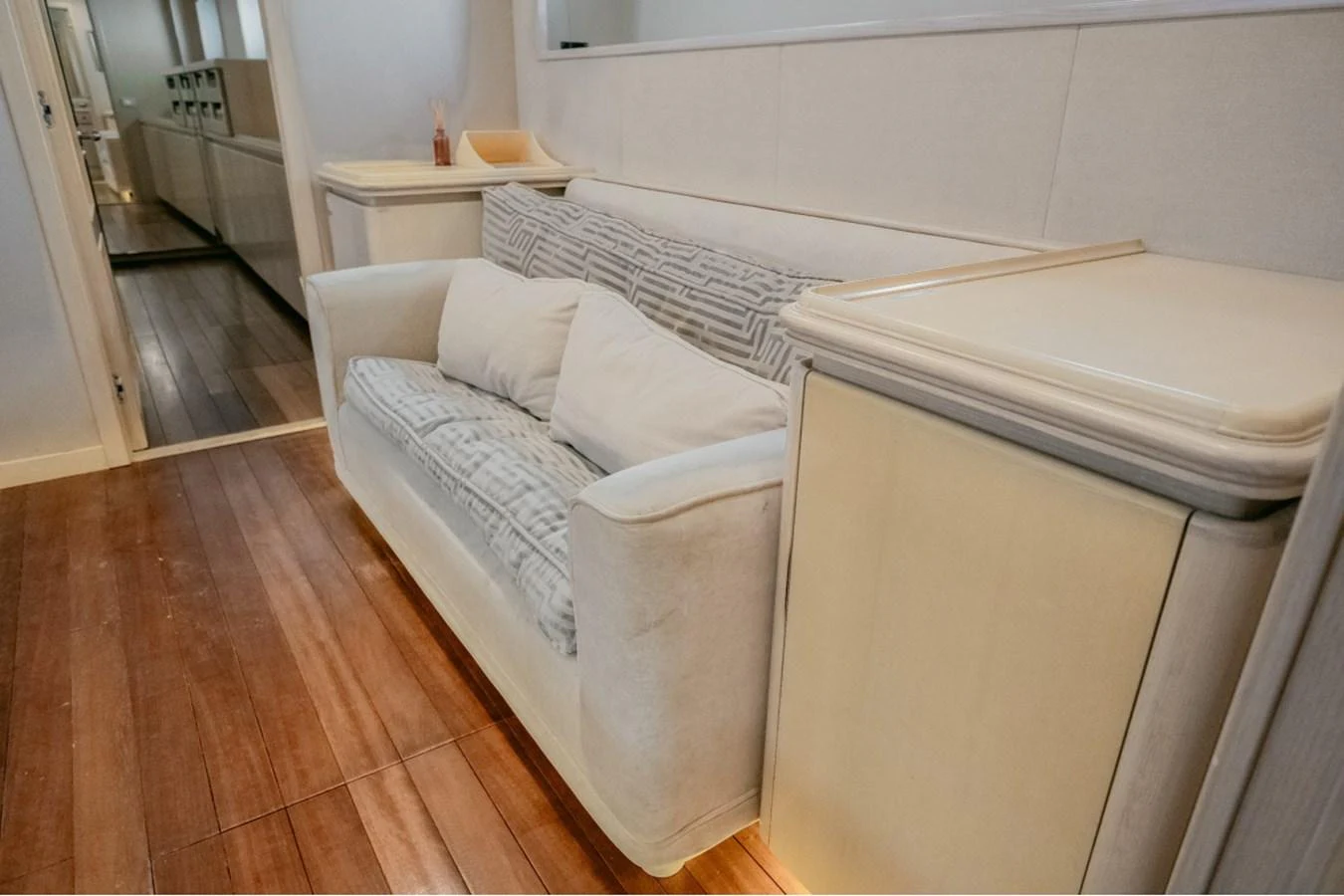 The interior features a cozy seating area with plush cushions and elegant wooden flooring. aboard PARSLEY Yacht for Sale