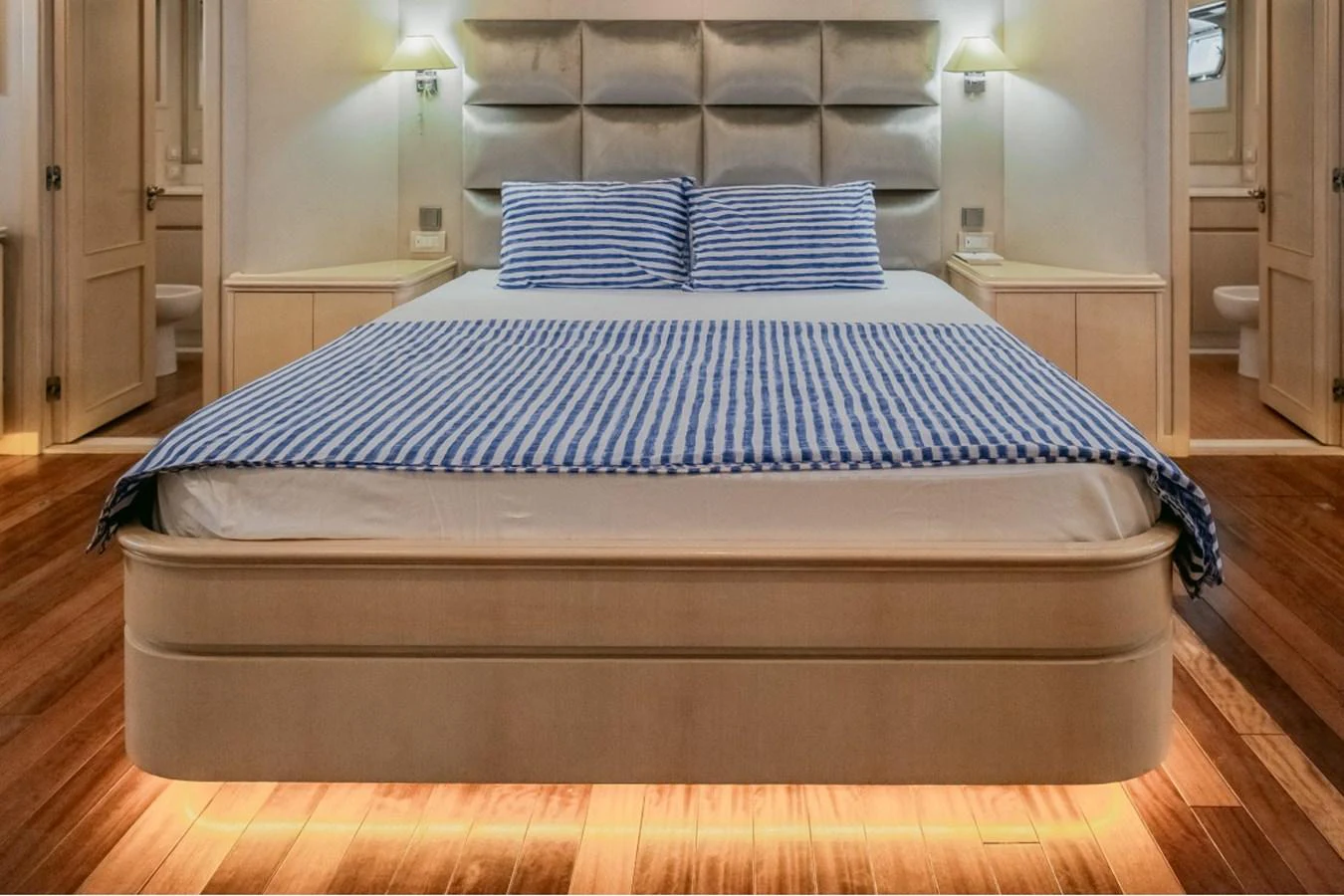 The master stateroom features a luxurious bed with elegant lighting and modern decor. aboard PARSLEY Yacht for Sale