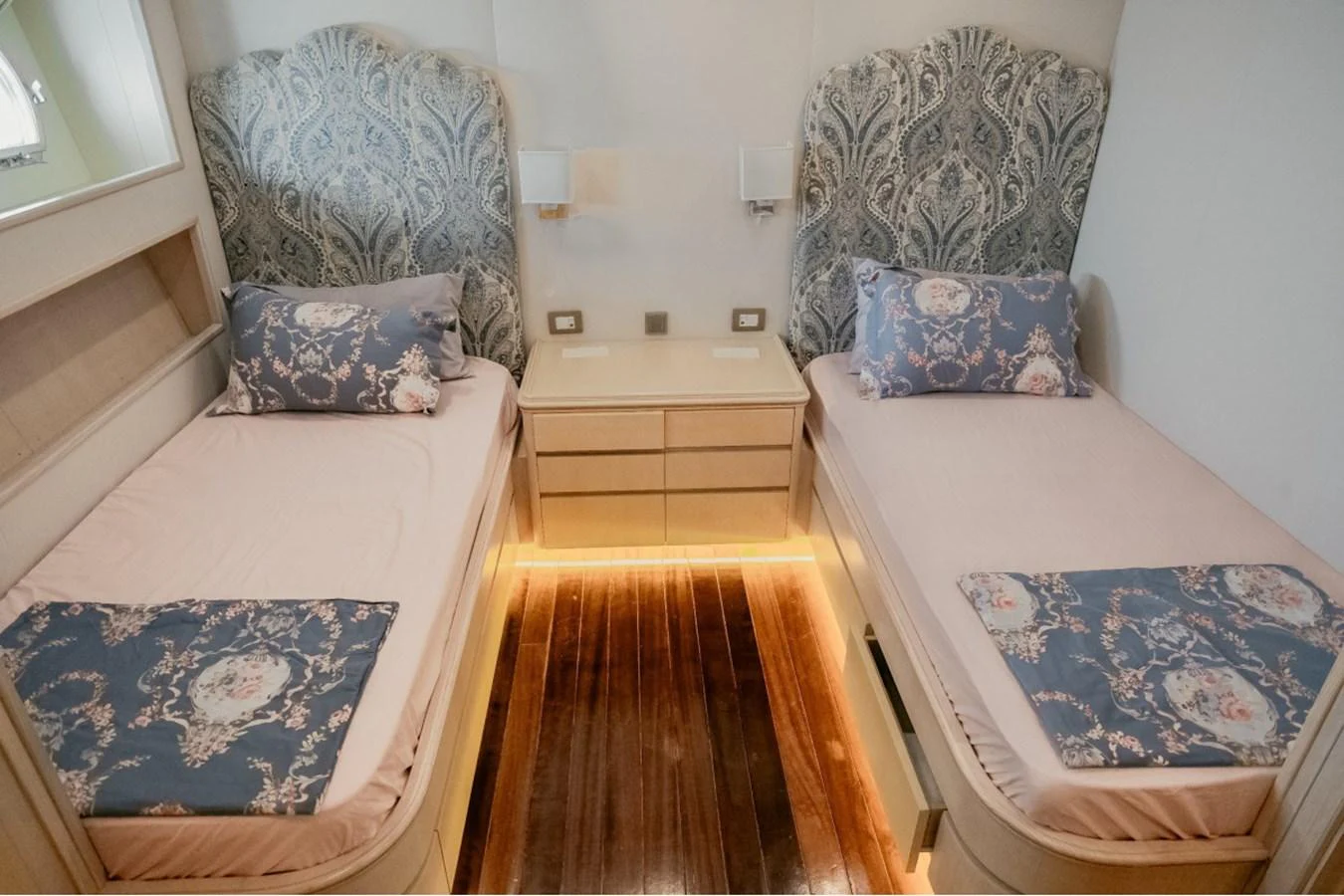 A cozy twin stateroom with elegant bedding and ambient lighting. aboard PARSLEY Yacht for Sale