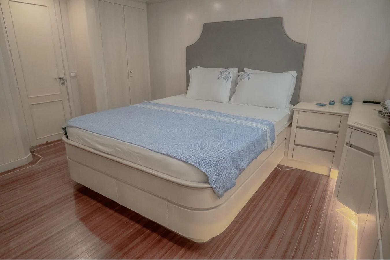 The stateroom features a comfortable bed with elegant bedding and soft lighting, creating a serene and inviting atmosphere. aboard PARSLEY Yacht for Sale