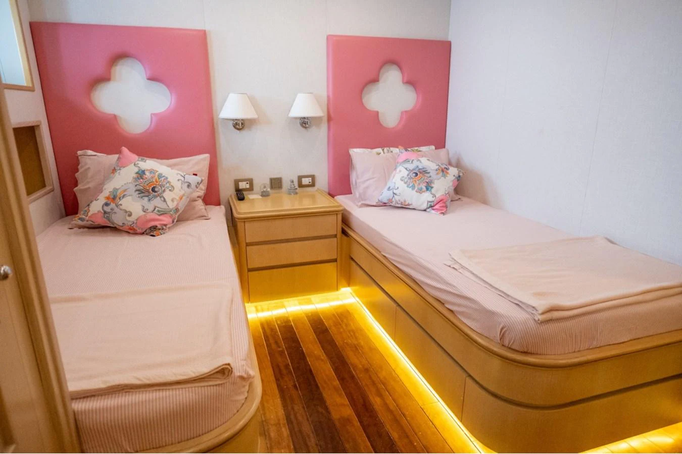 This cozy twin stateroom features modern decor with soft lighting and comfortable bedding. aboard PARSLEY Yacht for Sale
