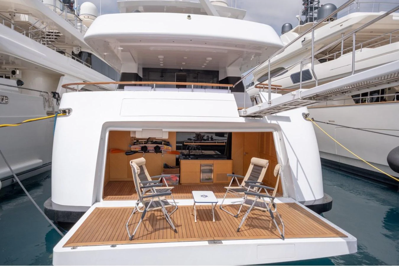 The yacht's aft deck features a cozy seating area with foldable chairs and a small table, perfect for relaxation. aboard PARSLEY Yacht for Sale