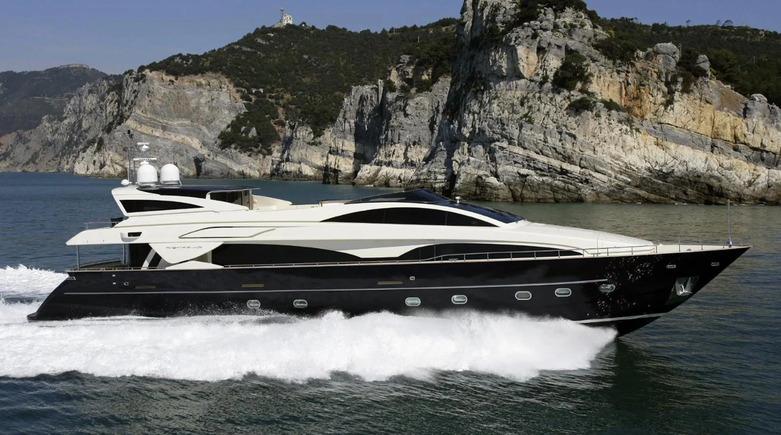 A sleek, modern yacht cruises swiftly along the coastline, showcasing its elegant design and powerful performance. aboard RIVA 115 Yacht for Sale