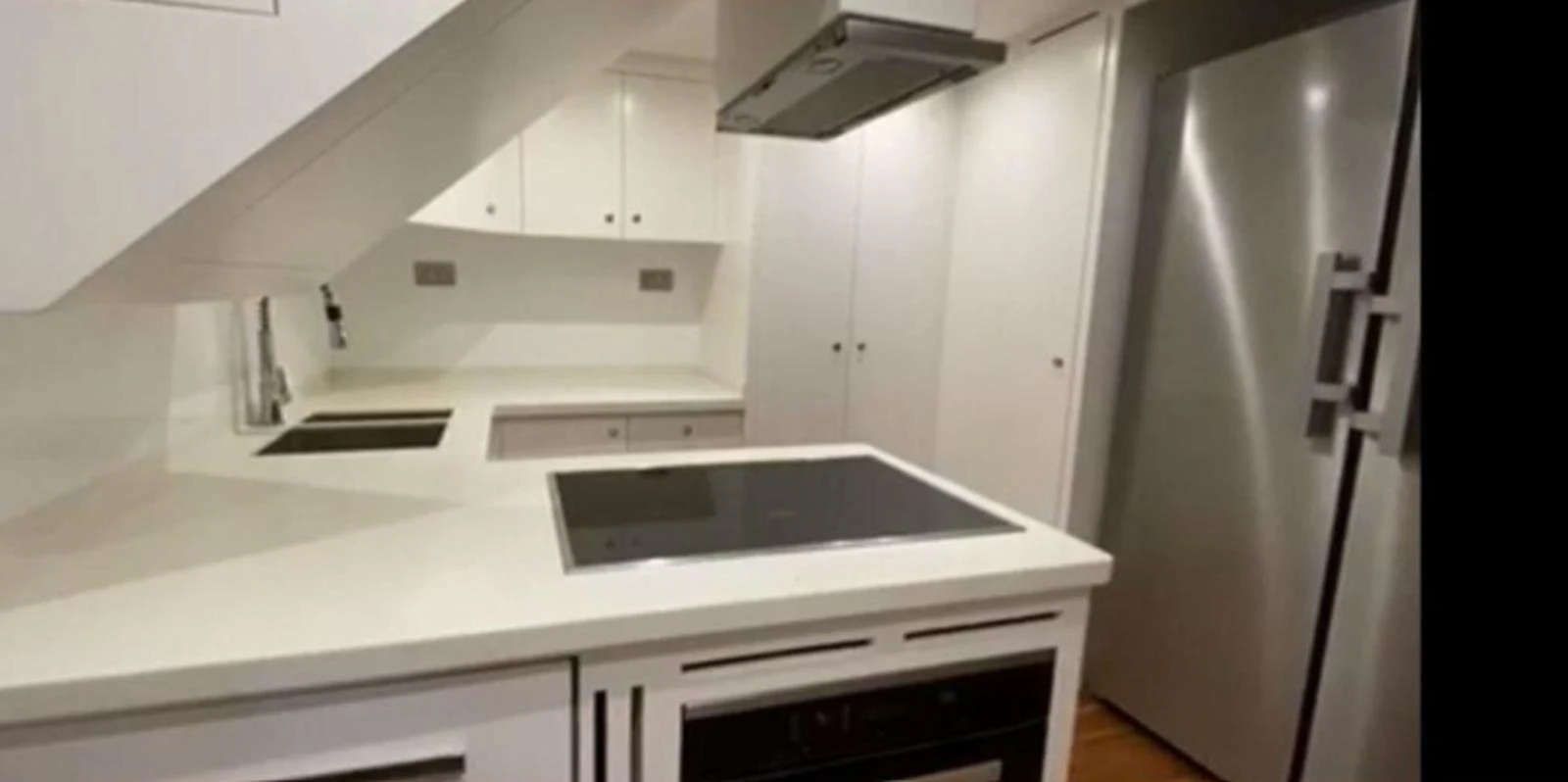 The yacht's galley features modern appliances and a sleek, minimalist design. aboard RIVA 115 Yacht for Sale