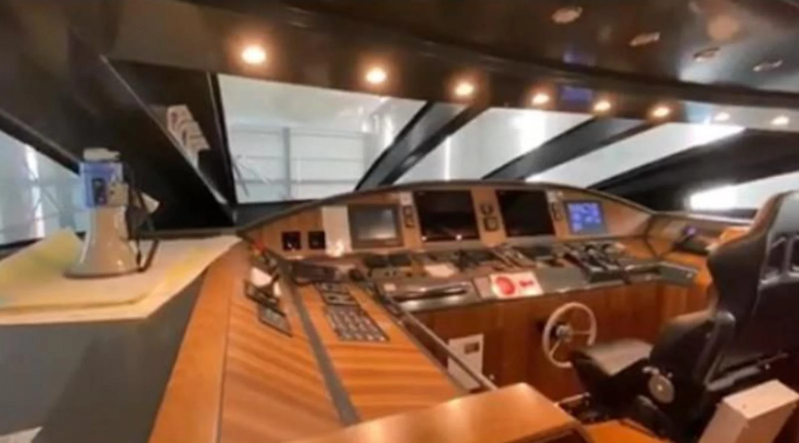 The helm station features advanced navigation equipment and luxurious wood finishes. aboard RIVA 115 Yacht for Sale