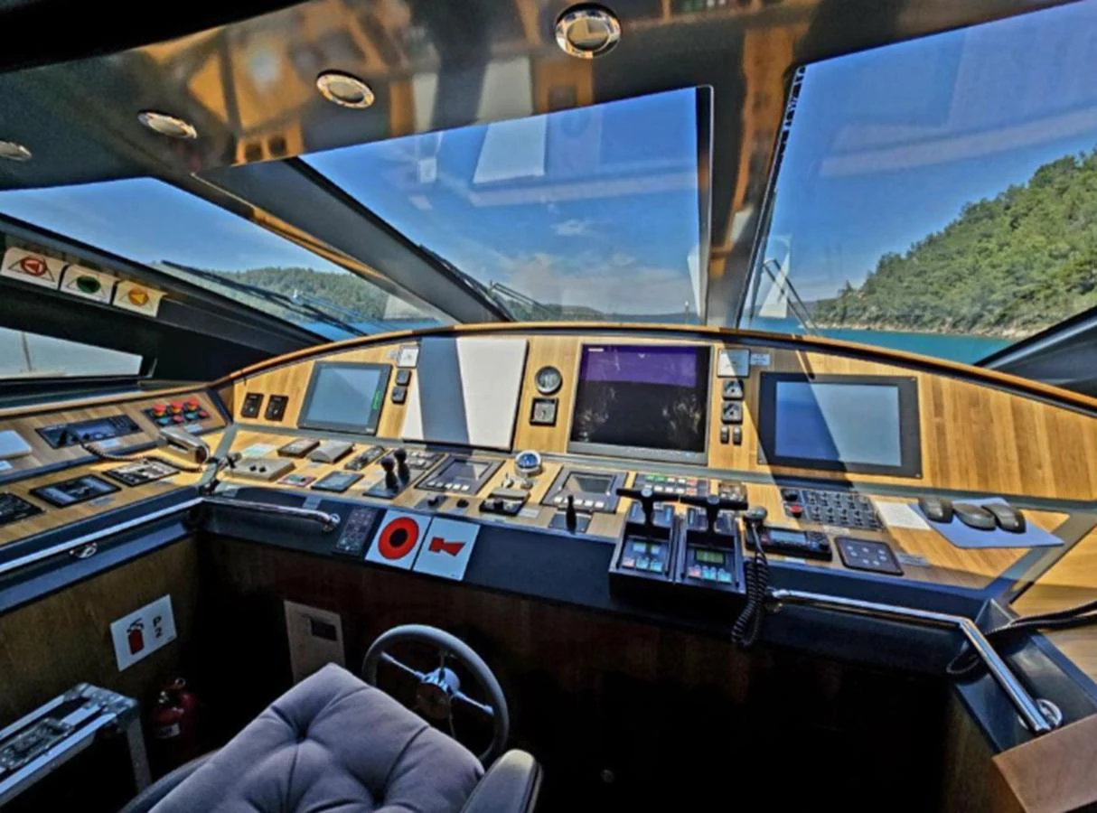 The helm station features advanced navigation equipment and a panoramic view through large windows. aboard RIVA 115 Yacht for Sale