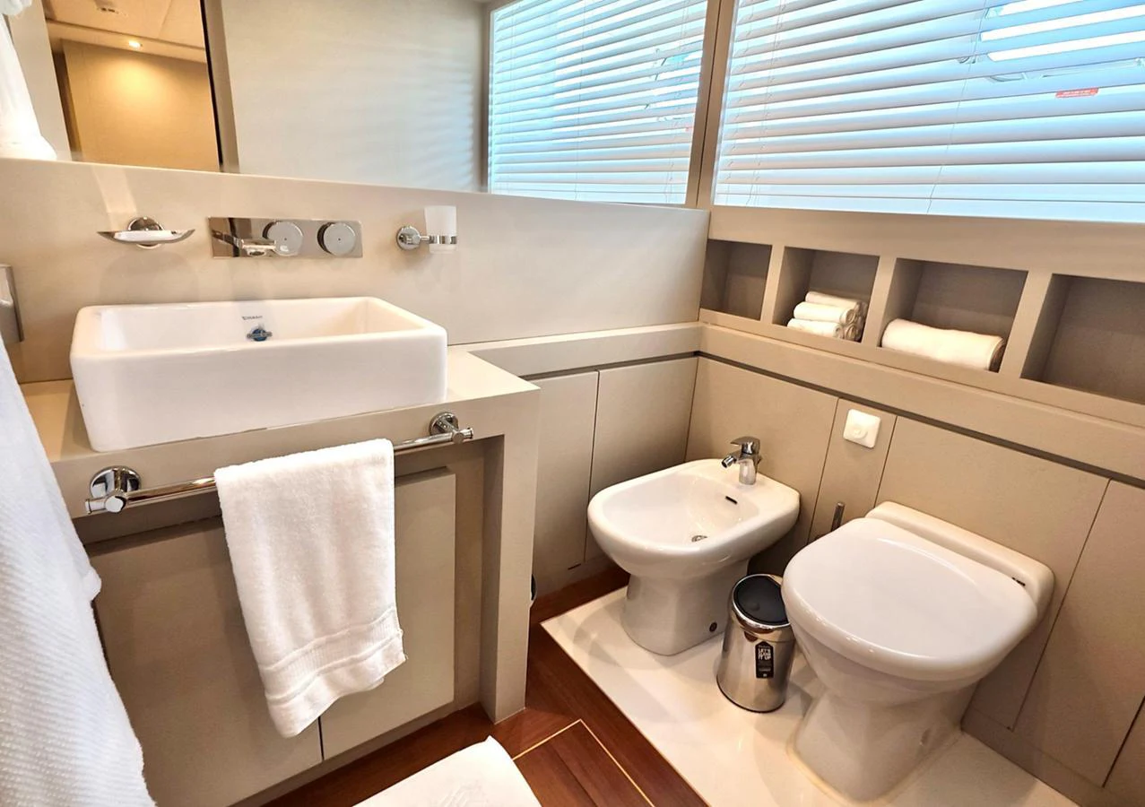 The yacht's bathroom features modern fixtures and a clean, elegant design. aboard RIVA 115 Yacht for Sale