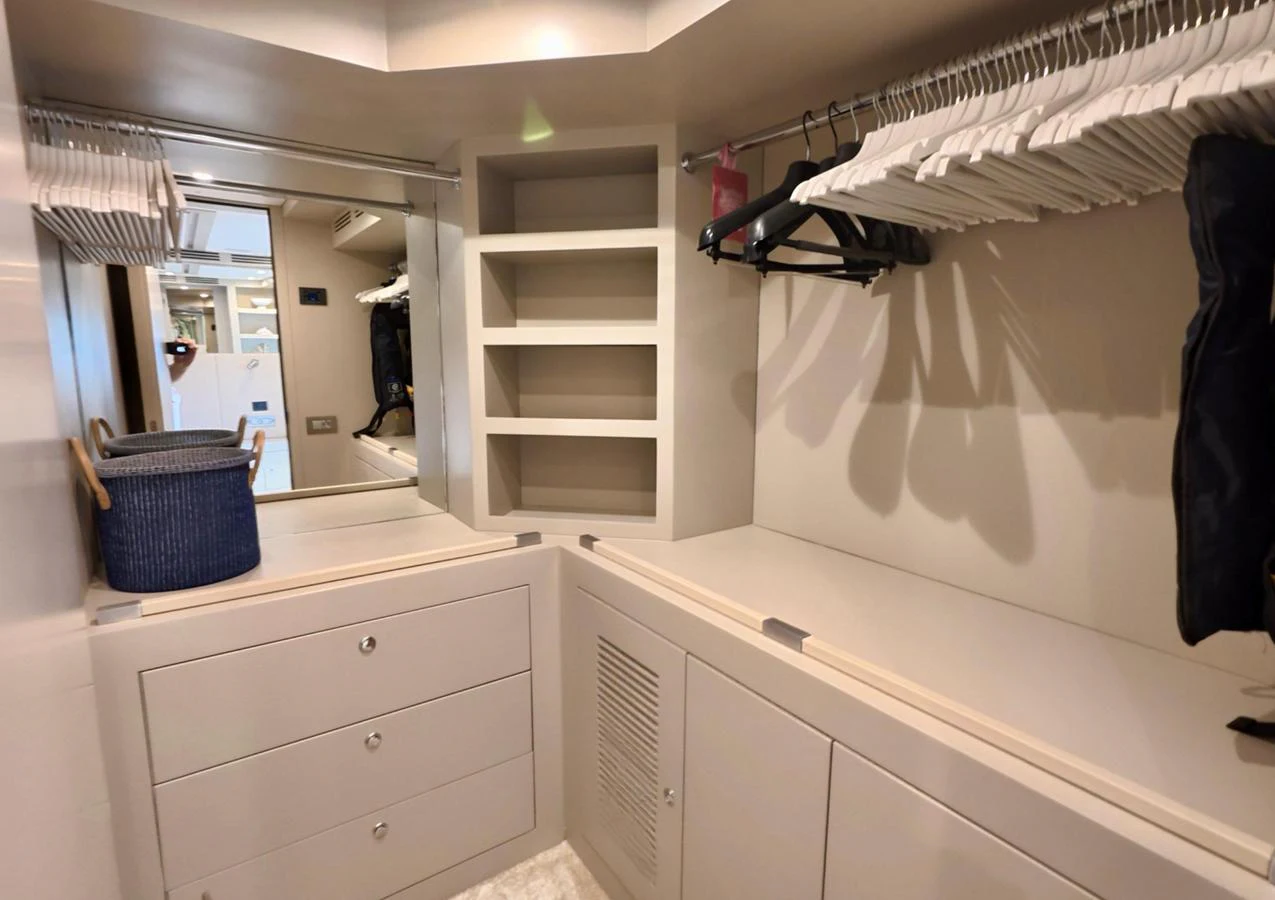 A spacious and well-organized closet with ample storage and hanging space. aboard RIVA 115 Yacht for Sale
