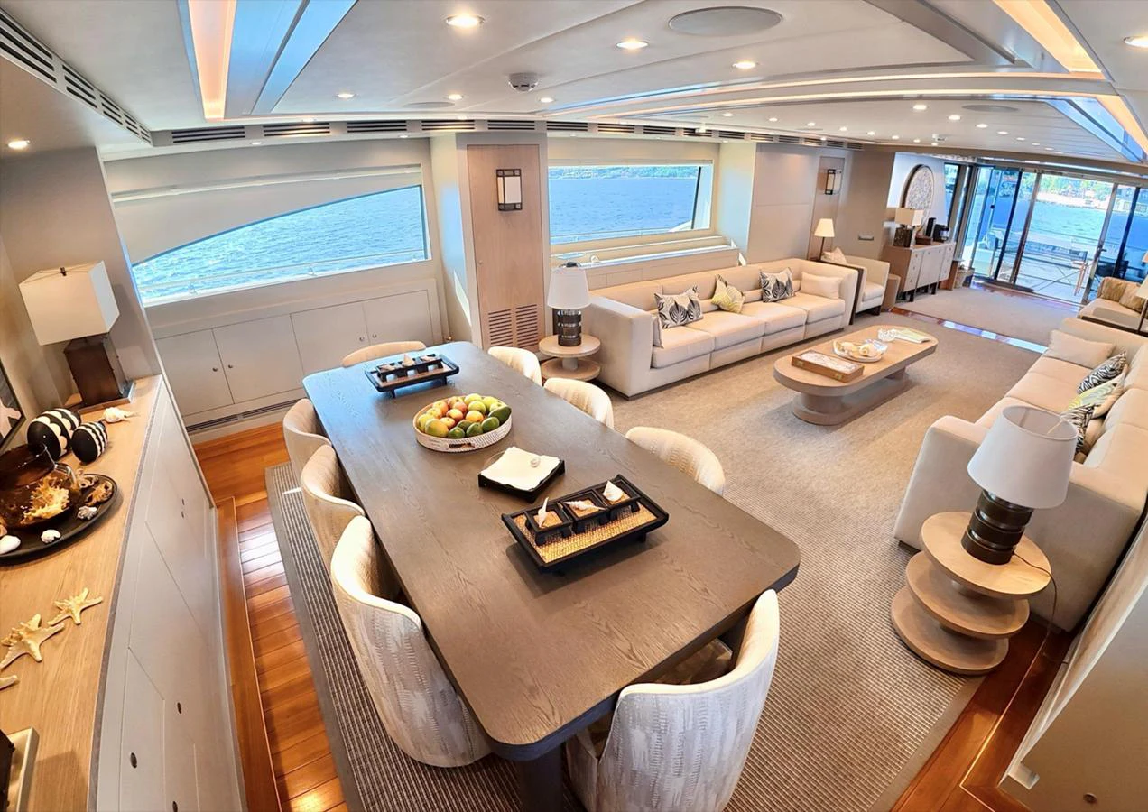 The spacious salon features elegant furnishings and large windows offering stunning ocean views. aboard RIVA 115 Yacht for Sale