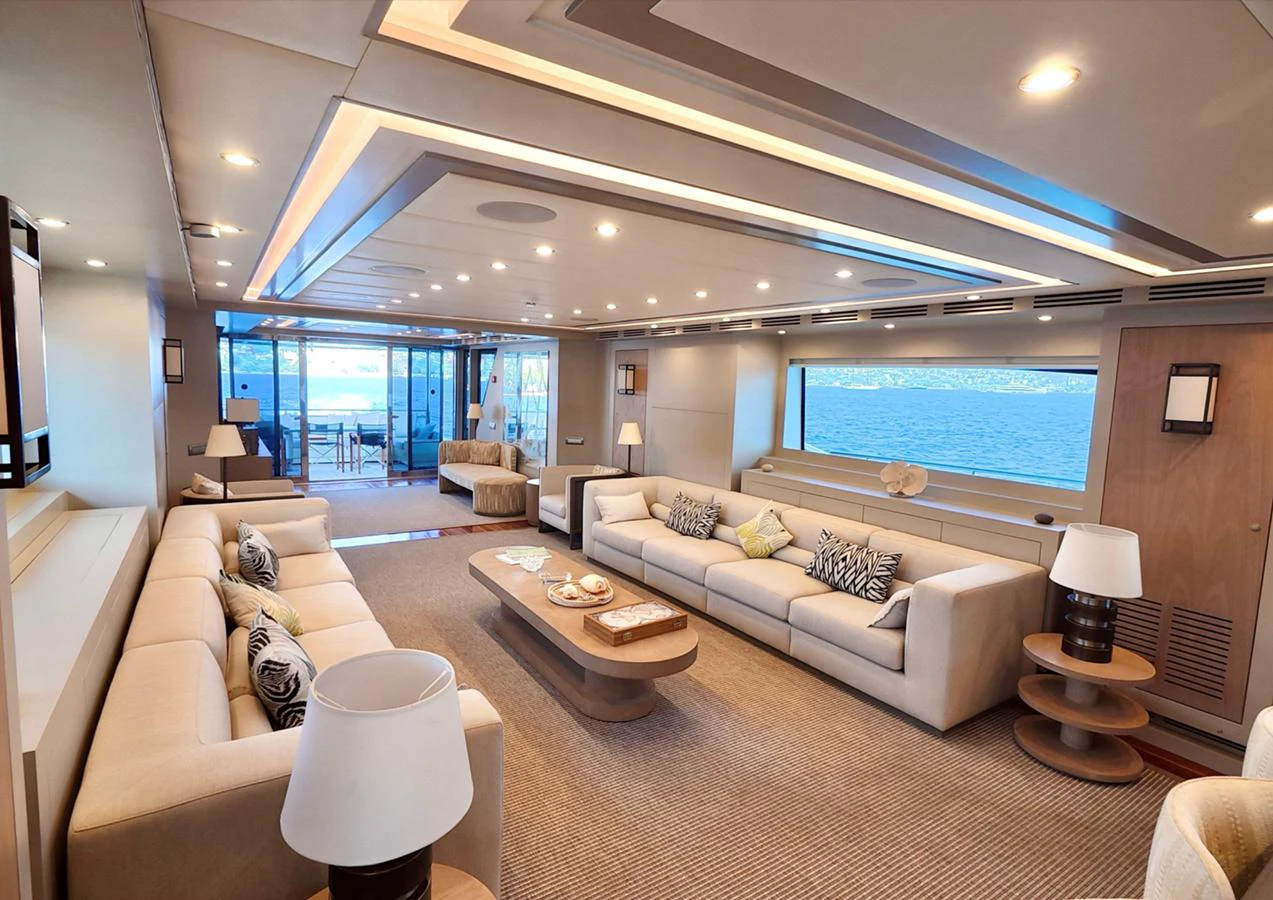 The spacious salon offers luxurious seating with panoramic ocean views. aboard RIVA 115 Yacht for Sale